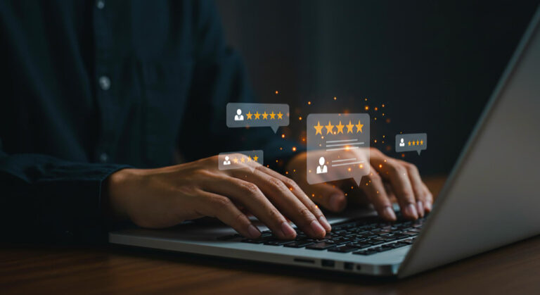 man on his laptop replying to google reviews using AI